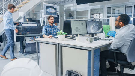 In the Busy Engineering Facility: Diverse Group of Engineers, Technicians, Specialists Working on...