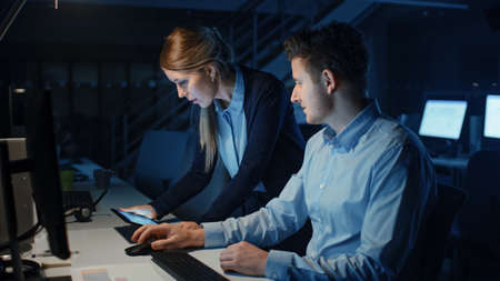 Ambitious and Confident Businessman Uses Desktop Computer, His Female Project Manager Explains...