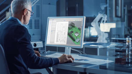 Engineer Works on Computer Uses CAD Software to Design 3D Industrial Machinery Component. In the...