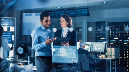 In Technology Research Facility: Female Project Manager Talks With Chief Engineer, they Consult...