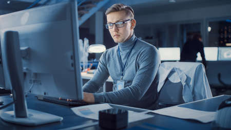 Professional Electronics Development Engineer Working on a Personal Computer in the Advanced...