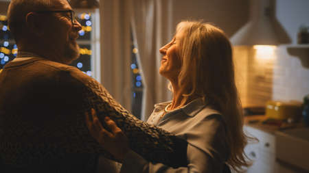 Senior Couple in Love Have Romantic Evening, Dancing in the Kitchen, Celebrating Anniversary....