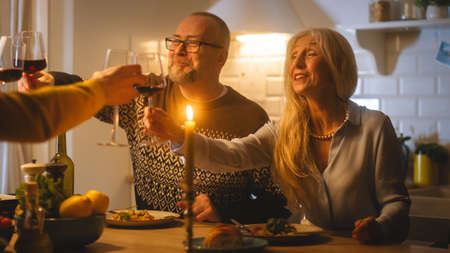 Happy Family Celebrating together, Sitting at the Table Eating Delicious Dinner Meal. Young Husband,...