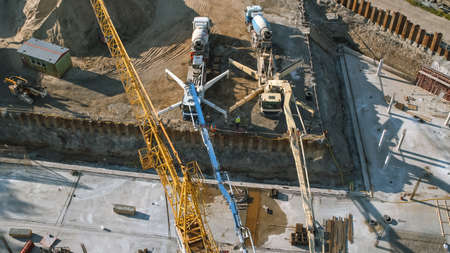 Aerial Shot of a New Constructions Development Site with High Tower Cranes Building Real Estate and...