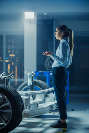 Automotive Design Engineer Thinking About Electric Car Chassis Prototype. In Innovation Laboratory...