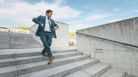 Cheerful and Happy Businessman in a Suit is Holding Coffee and Actively Dancing While Walking Down...