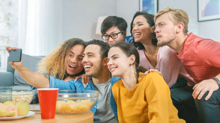 At Home Diverse Group of Friends Doing Collective Selfie, Guy Holds Smartphone People Smile, Laugh...