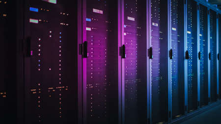 Shot of Dark Data Center With Multiple Rows of Fully Operational Server Racks. Modern...