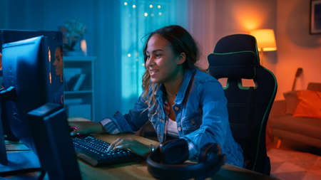 Beautiful Surprised and Excited Young Black Girl Watching Action Video on a Computer. She Has Dark...