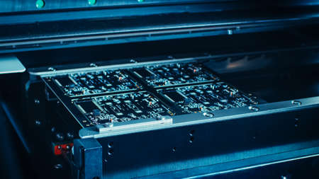 Factory Machine at Work: Printed Circuit Board Being Assembled with Automated Robotic Arm, Surface...