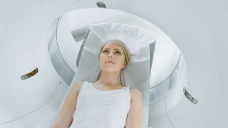 In Medical Laboratory Male Radiologist Controls MRI or CT or PET Scan with Female Patient Undergoing...