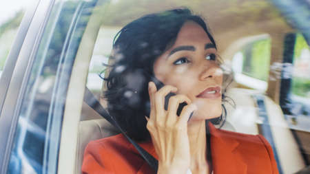Beautiful Woman Traveling in a Car, Sitting on a Passenger Seat Uses Smartphone, Makes a Call....