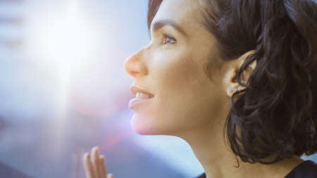 Close-up Portrait of the Beautiful Young Businesswoman Looking Thoughtfully out of Her Office...