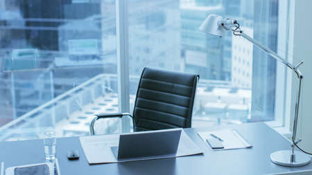 High Angle Shot of a Working Desk of an Successful Person in Office with Cityscape Window View.の写真素材