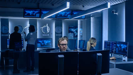 Diverse Team of Corporate Businesspeople Work on Computers and Have Meeting about Logistics of...