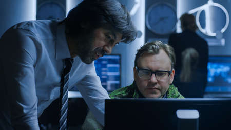 Government Chief of Cyber Security Agent Consults Military Officer who Works on Computer....
