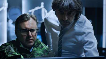 Government Chief of Cyber Security Consults Military Officer who Works on Computer. Specialists...
