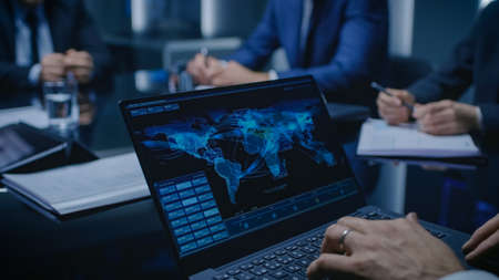On the Table Laptop Showing World Data Flow: Team of Politicians, Corporate Business Leaders and...