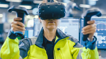 Portrait Female Mechanical Engineer Wearing Virtual Reality Headset and Using Controllers, She Uses...