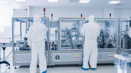 Manufacturing Laboratory where Scientists in Protective Coveralls Work with Industrial High...
