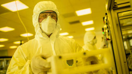 Scientist in Sterile Protective Clothing Work on a Modern Industrial 3D Printing Machinery....