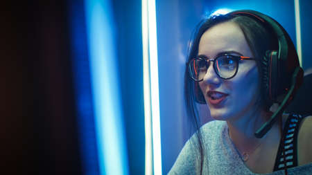 Close-up Portrait of the Beautiful Professional Gamer Girl Playing in Online Video Game, Casual Cute...