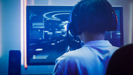 Professional Gamer Playing in First-Person Shooter Online Video Game on His Personal Computer. Hes...