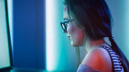 Close-up Portrait of the Beautiful Professional Gamer Girl Playing in Online Video Game, Casual Cute...