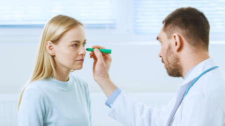 Over the Shoulder Shot of a Plastic Cosmetic Surgeon Draws Lines on a Face of a Beautiful Female...