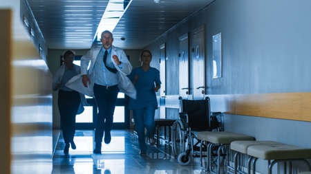 Emergency in the Hospital, Doctors and Nurses Running through the Hallway, in a Hurry to Save Lives.