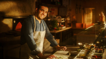 In Restaurant Professional Chef Preparing Pizza, Kneading Dough, Adding Ingredients, Special Sauce, Traditional Family Recipe. Authentic Italian Pizzeria with Delicious Organicの写真素材