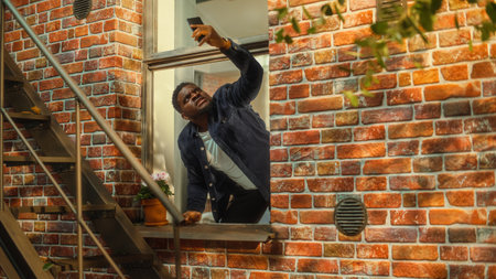 Distressed Young Black Man Doesn't Understand Why There is No Cellular Connection on His Smartphone, Frantically Reaching Out to the Sky with a Mobile Phone fromの写真素材