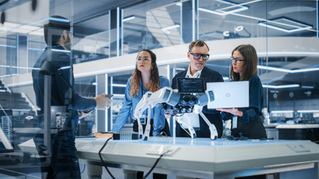 Professional Multicultural Team of Female and Male Engineers Use Industrial Programmable Robot...