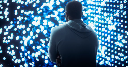 Black Young Man Looking at Big Screen with Neural Network Visualisation In 3D. Professional Computer Data Science Engineer Working in System Control andの素材