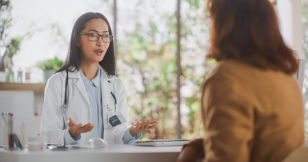 Portrait of an Asian Healthcare Professional Listening to a Senior Female Patient Before Prescribing Treatment for Her Medical Condition During a Consultation in aの写真素材