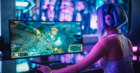 Young Woman Playing Online RPG Strategy Video Game on a Computer in a Futuristic Digital Space. Cosplay Girl with Blue Hair Streaming Entertainment Content for Internet Fans. Overの写真素材