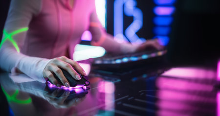 Close Up of a Female Gamer Girl Playing on a Computer. Focus on Hands Using Keyboard and Mouse....