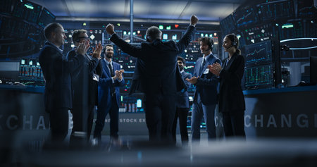 Team of Successful Stock Exchange Brokers Celebrating a Profitable Investment Bid on a Securities Market. Diverse Specialists and Asset Managers Clapping, Cheering, Shaking Handsの写真素材