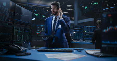 Portrait of a Young Handsome Stock Exchange Broker Working on a Tablet Computer, Researching Stocks...