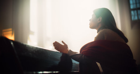 Young Christian Woman Sits Piously in Majestic Church, with Folded Hands She Seeks Guidance From...