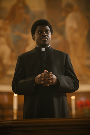 Service In Christian Church: Minister Leads Congregation In Prayer, Quotes The Bible, Gospel and Teaching of Jesus and the Prophets. Portrait of Priest Doing Sermon that Gives Hopeの写真素材