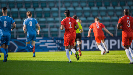 Stadium Soccer Football Match International Championship. Blue And Red Team Defence Players Running Behind Forward, Defending Positions. World Tournament. Live Sports Broadcastの写真素材