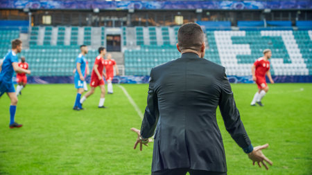 Professional Soccer Football Match Championship on Stadium with Disappointed Coach Training Players. Teams Attacks, Plays in Pass, Dribble. Major League Cup World Tournamentの写真素材