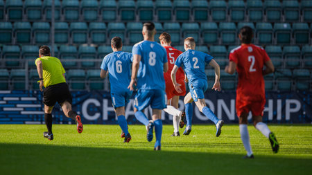 Stadium Soccer Football Match International Championship. Blue And Red Team Defence Players Running Behind Forward, Defending Positions. World Tournament. Live Sportsの写真素材