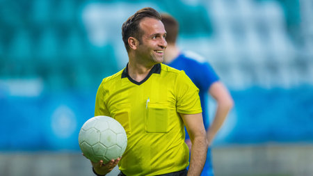 International Soccer Football Championship Match: Portrait of Professional Referee Holding a Ball. Tournament Beginning, Players Ready For Kick Off. Waiting forの写真素材