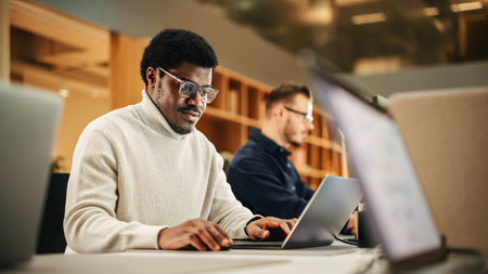 Portrait of Enthusiastic Black Man Turning on his Laptop and Starting his Work Day at the Office....