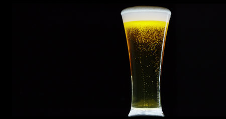 Glass of beer isolated on a black background. Beer in a glassの写真素材