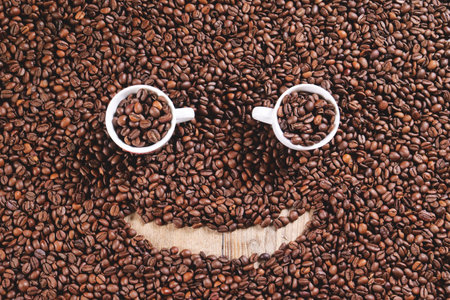 Coffee beans with smiley face on wooden background, top view