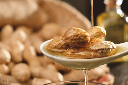 Peanut oil in a glass bowl on a wooden background. Selective focus.の写真素材