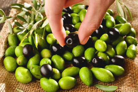 olives and green olives on a wooden table, top viewの写真素材